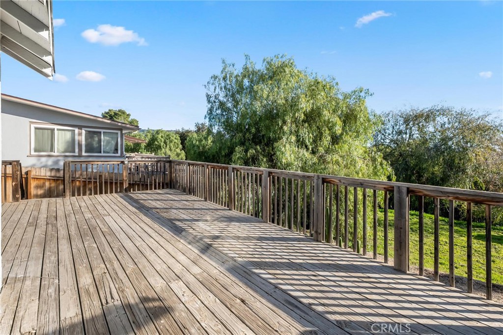 34789 Wildwood Canyon Road Yucaipa, CA 92399 - Photo 38 of 52 a view of deck with wooden floor and fence with plants