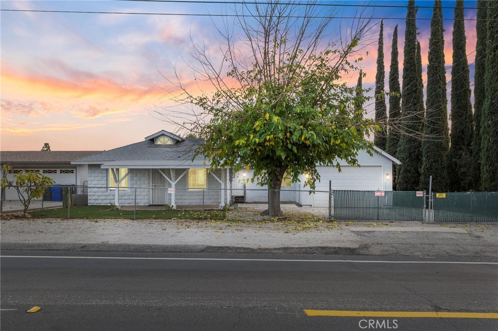 34789 Wildwood Canyon Road Yucaipa, CA 92399 - Photo 5 of 52 a view of a house with a tree and a yard