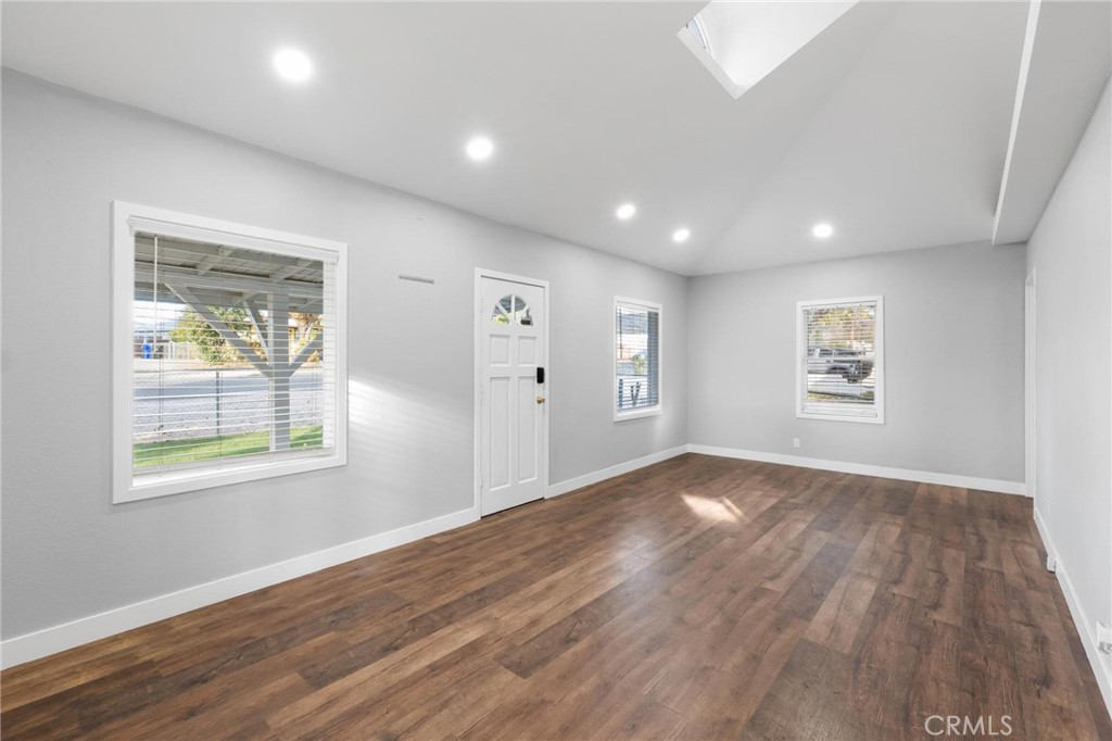34789 Wildwood Canyon Road Yucaipa, CA 92399 - Photo 8 of 52 an empty room with wooden floor and windows
