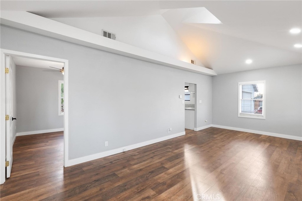 34789 Wildwood Canyon Road Yucaipa, CA 92399 - Photo 9 of 52 a view of an empty room with wooden floor and a window