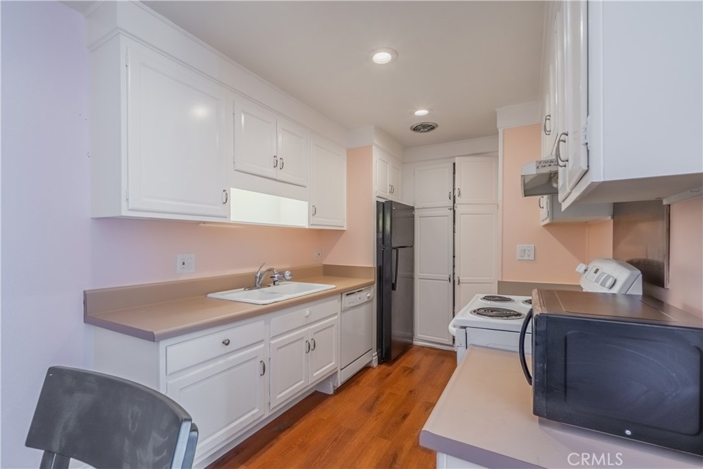 2103 Ronda Granada, Unit B Laguna Woods, CA 92637 - Photo 14 of 22 a kitchen with stainless steel appliances granite countertop a sink stove and refrigerator