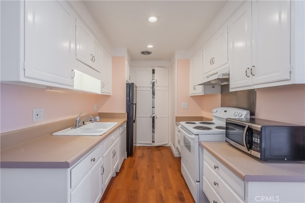 2103 Ronda Granada, Unit B Laguna Woods, CA 92637 - Photo 15 of 22 a kitchen with stainless steel appliances granite countertop a sink stove and refrigerator