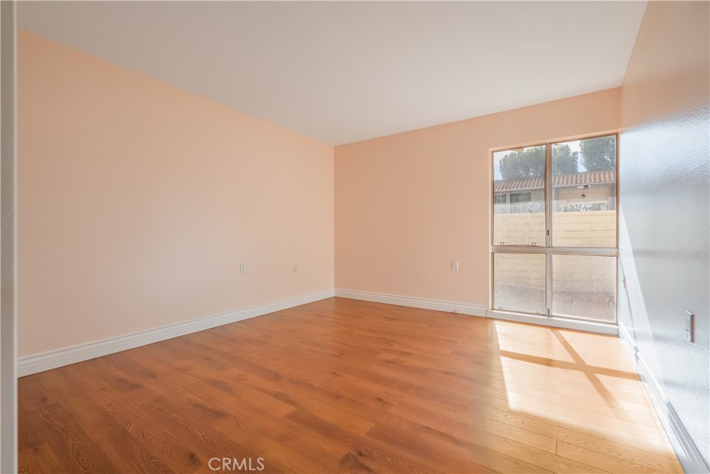 2103 Ronda Granada, Unit B Laguna Woods, CA 92637 - Photo 16 of 22 an empty room with wooden floor and windows