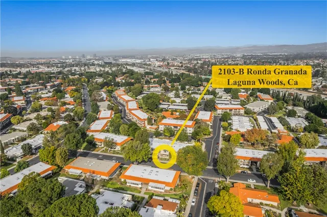 an aerial view of residential houses with yard and ocean view