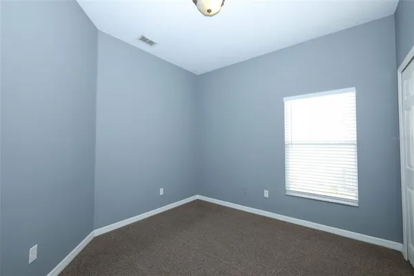 a view of an empty room with windows
