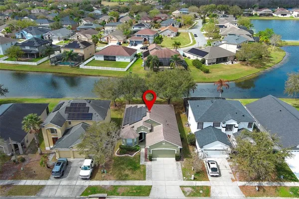 an aerial view of residential houses with outdoor space
