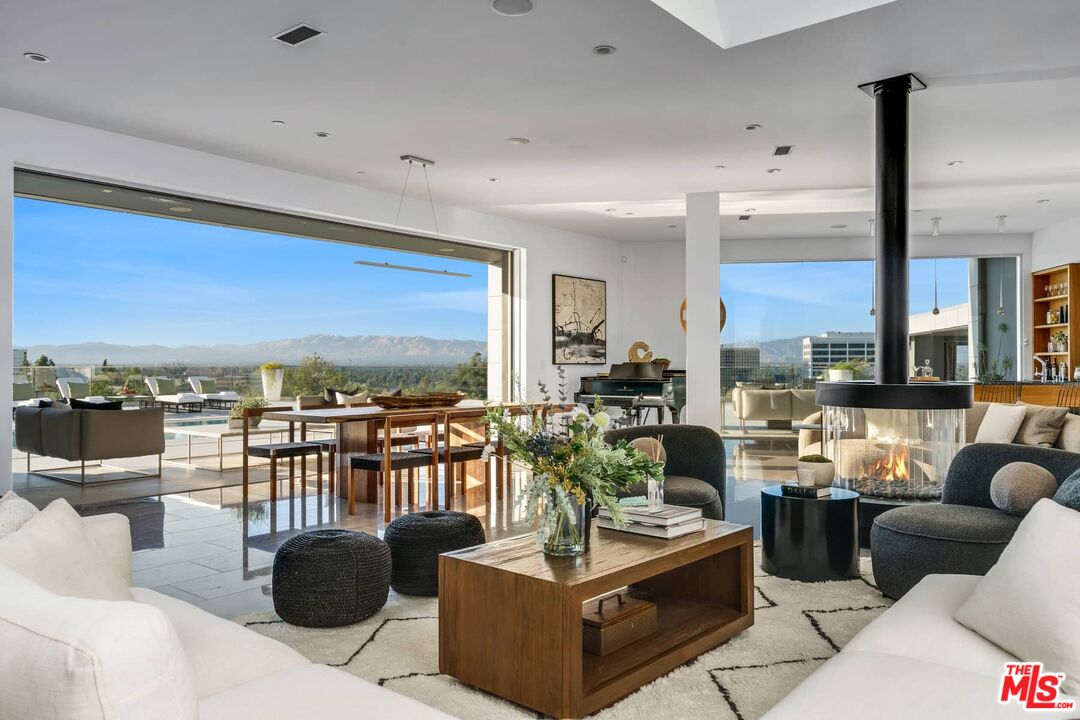 4634 Libbit Avenue Encino, CA 91436 - Photo 1 of 40 a living room with fireplace furniture and a large window