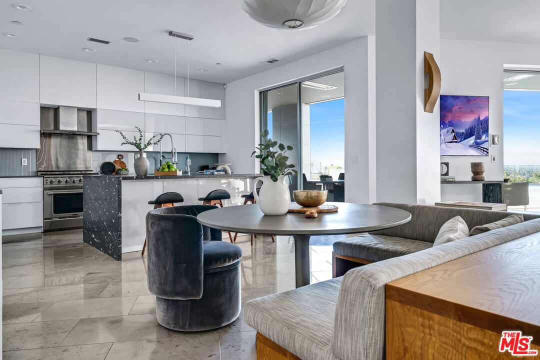 4634 Libbit Avenue Encino, CA 91436 - Photo 13 of 40 a kitchen with kitchen island granite countertop a sink counter top space appliances and cabinets