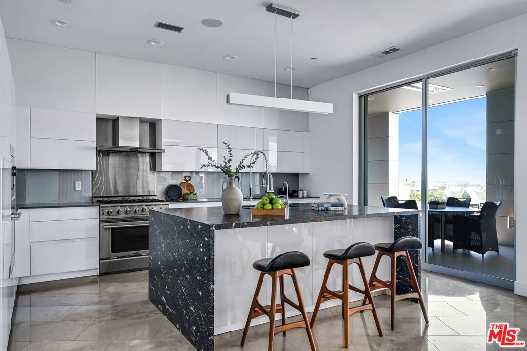 4634 Libbit Avenue Encino, CA 91436 - Photo 14 of 40 a kitchen with stainless steel appliances granite countertop a stove top oven a sink and cabinets