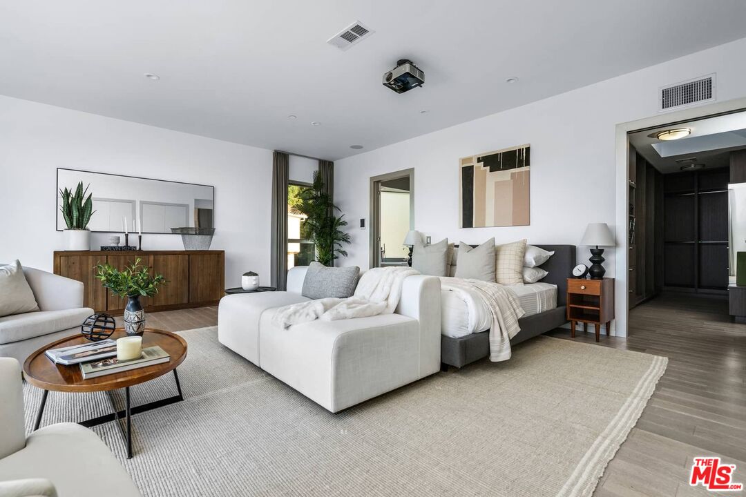 4634 Libbit Avenue Encino, CA 91436 - Photo 19 of 40 a spacious bedroom with a bed and a couch