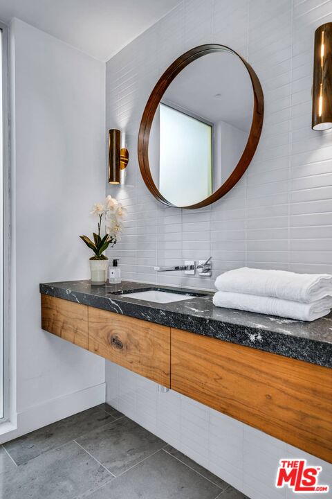 4634 Libbit Avenue Encino, CA 91436 - Photo 22 of 40 a bathroom with a sink and a mirror