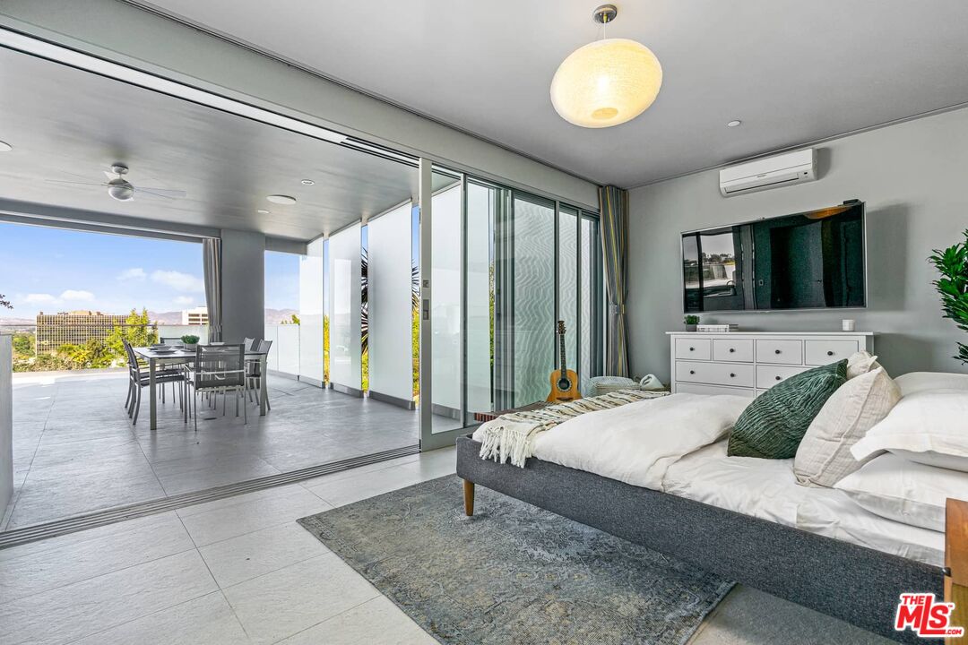 4634 Libbit Avenue Encino, CA 91436 - Photo 30 of 40 a living room with furniture and a flat screen tv