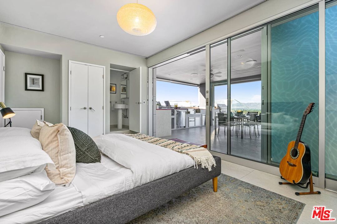 4634 Libbit Avenue Encino, CA 91436 - Photo 32 of 40 a bedroom with a bed and glass door