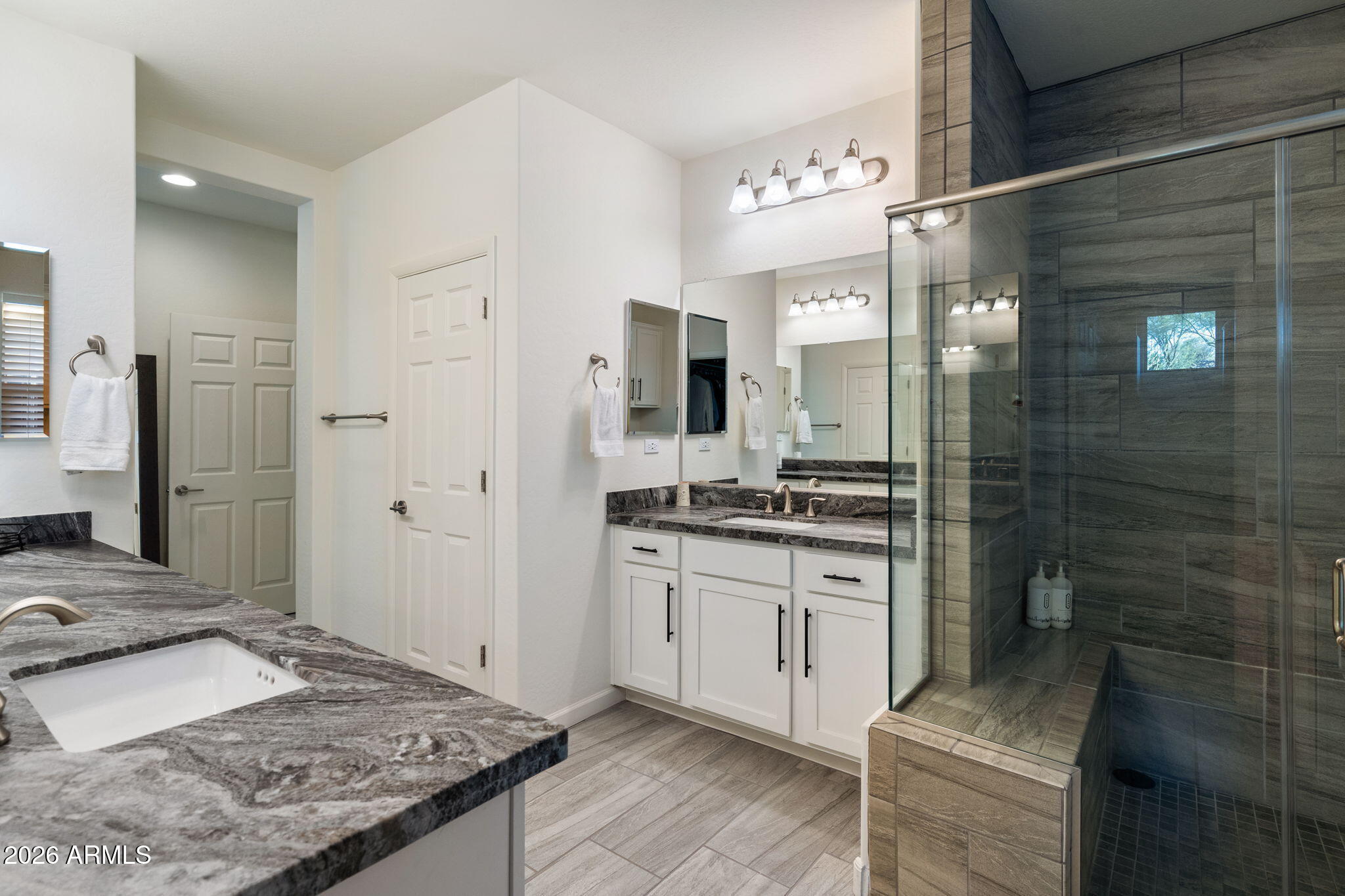 4638 Cactus Wren Road Wickenburg, AZ 85390 - Photo 14 of 31 a bathroom with a granite countertop sink a toilet a mirror and shower