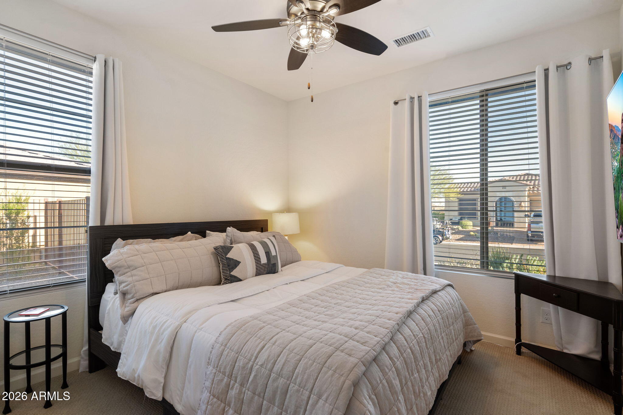 4638 Cactus Wren Road Wickenburg, AZ 85390 - Photo 17 of 31 a bedroom with a large bed and a chandelier