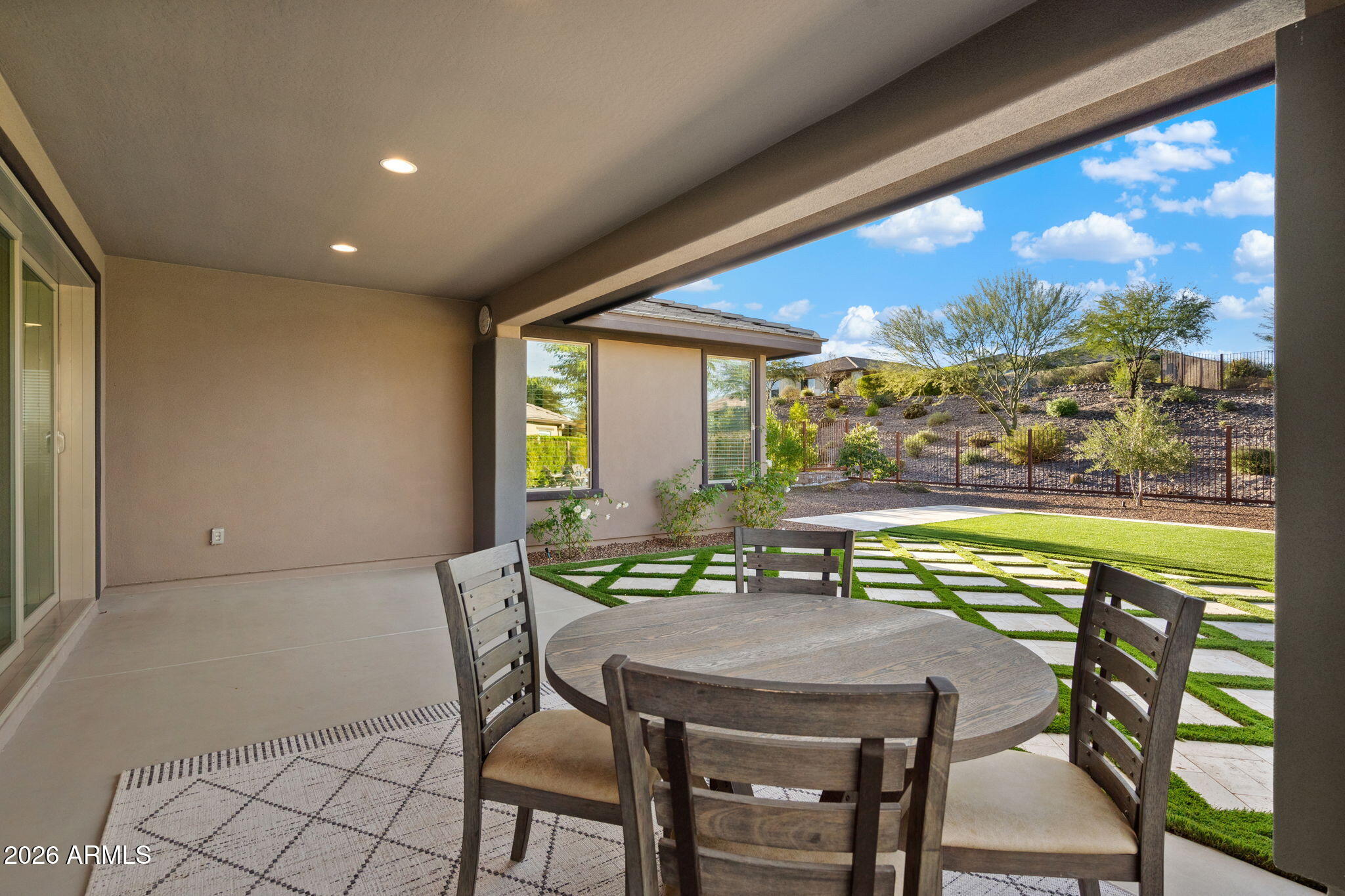 4638 Cactus Wren Road Wickenburg, AZ 85390 - Photo 20 of 31 a view of a dining room with furniture large windows and wooden floor