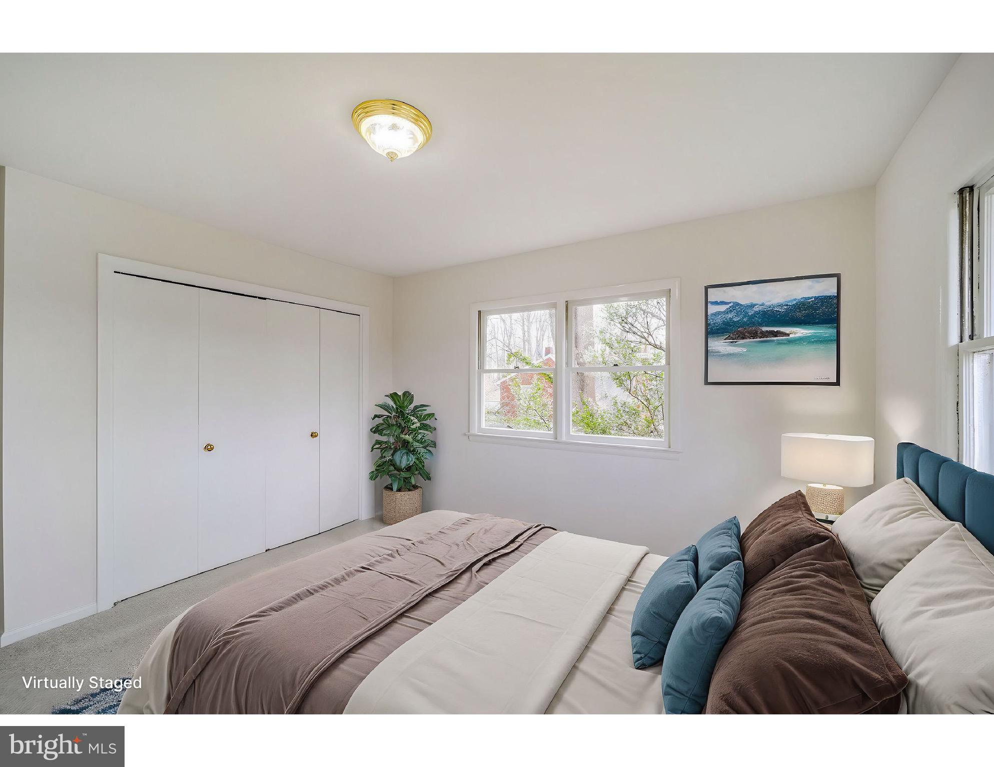 5017 Ravensworth Road Annandale, VA 22003 - Photo 20 of 40 a bedroom with a bed and painting on the wall