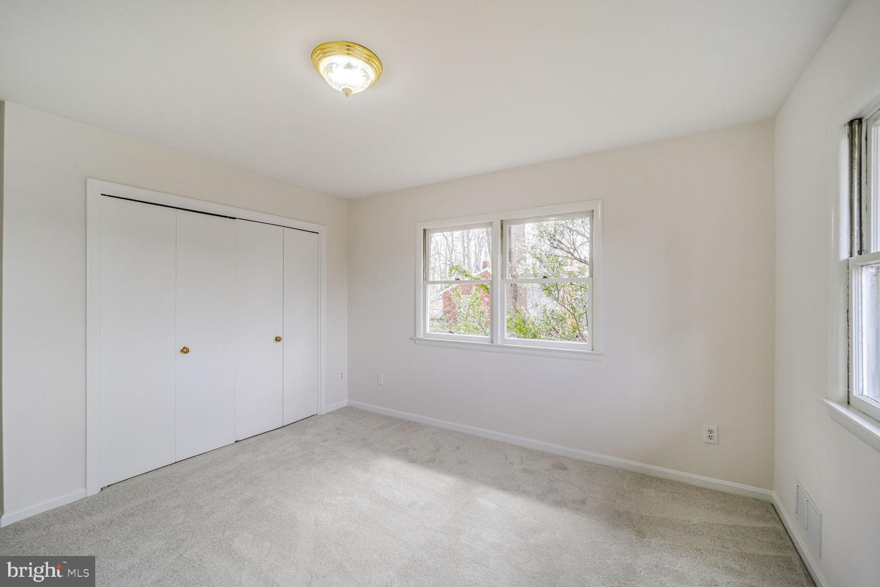 5017 Ravensworth Road Annandale, VA 22003 - Photo 21 of 40 a view of an empty room with a window and closet