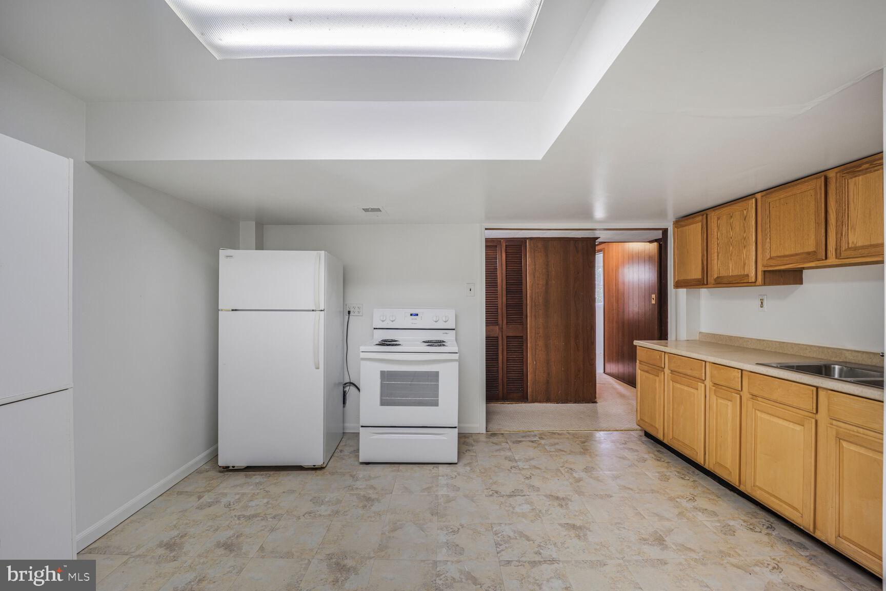 5017 Ravensworth Road Annandale, VA 22003 - Photo 29 of 40 a kitchen with stainless steel appliances a refrigerator and a stove