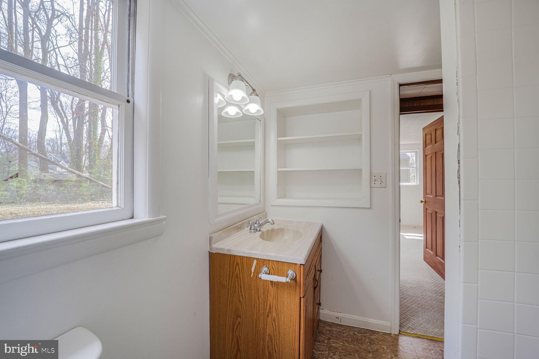 5017 Ravensworth Road Annandale, VA 22003 - Photo 34 of 40 a bathroom with a sink and a mirror