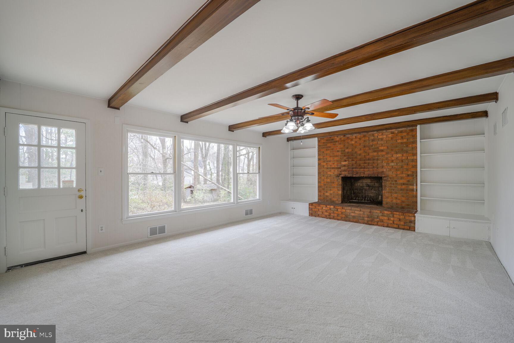 5017 Ravensworth Road Annandale, VA 22003 - Photo 6 of 40 an empty room with windows and fireplace