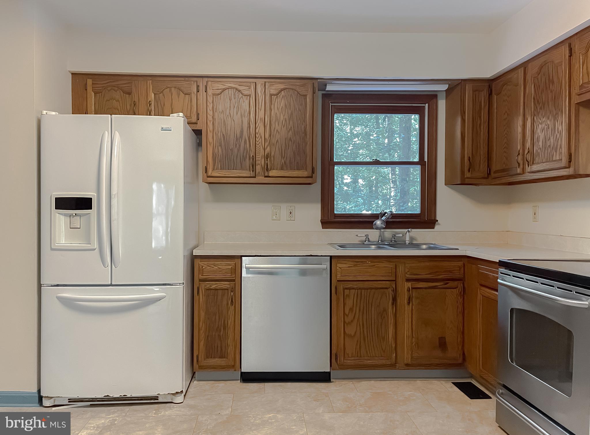 960 Bowie Shop Road Huntingtown, MD 20639 - Photo 17 of 69 a white refrigerator freezer sitting inside of a kitchen