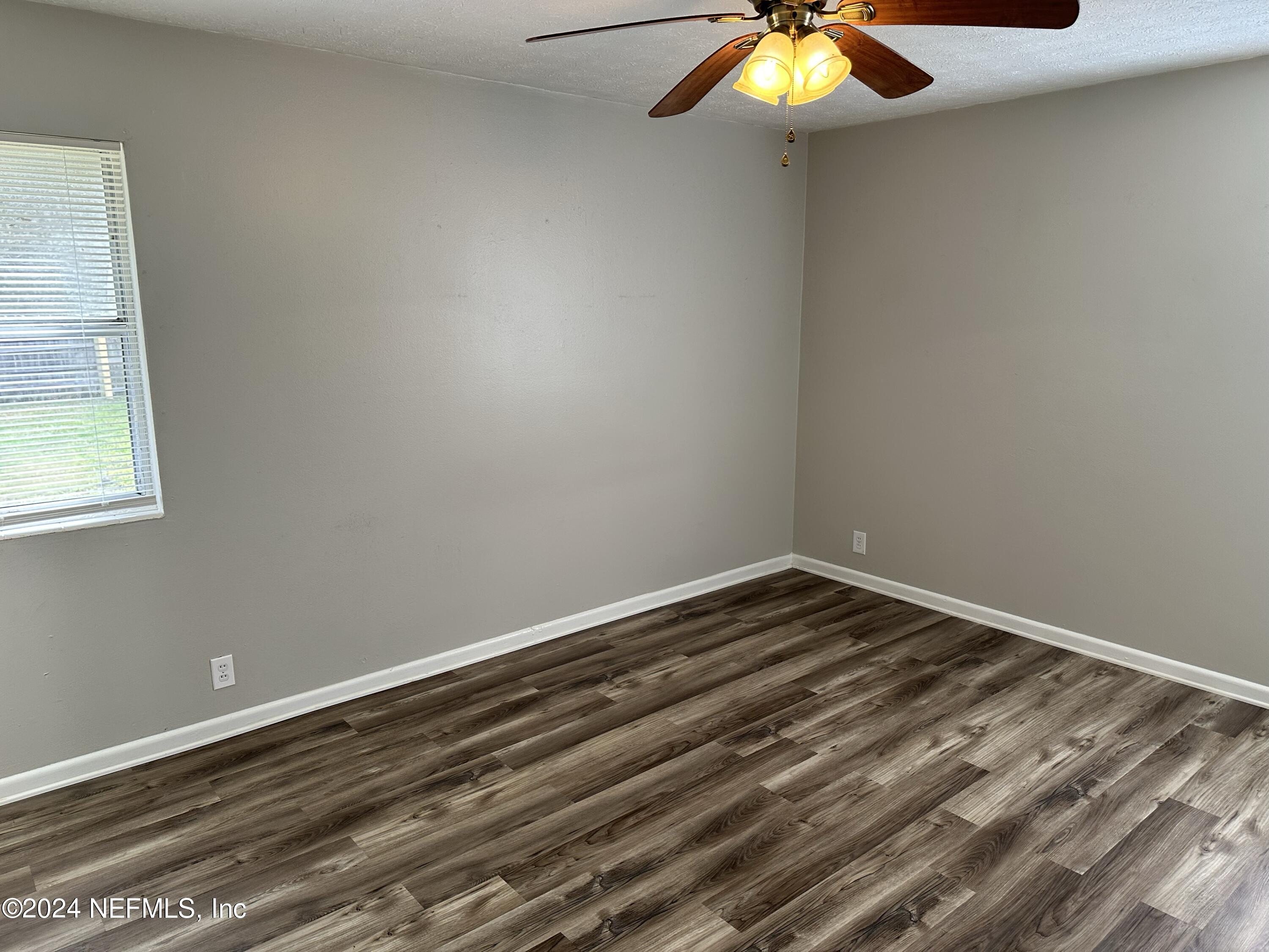 7417 Coral Sea Road Jacksonville, FL 32244 - Photo 6 of 10 a view of room with window and ceiling fan