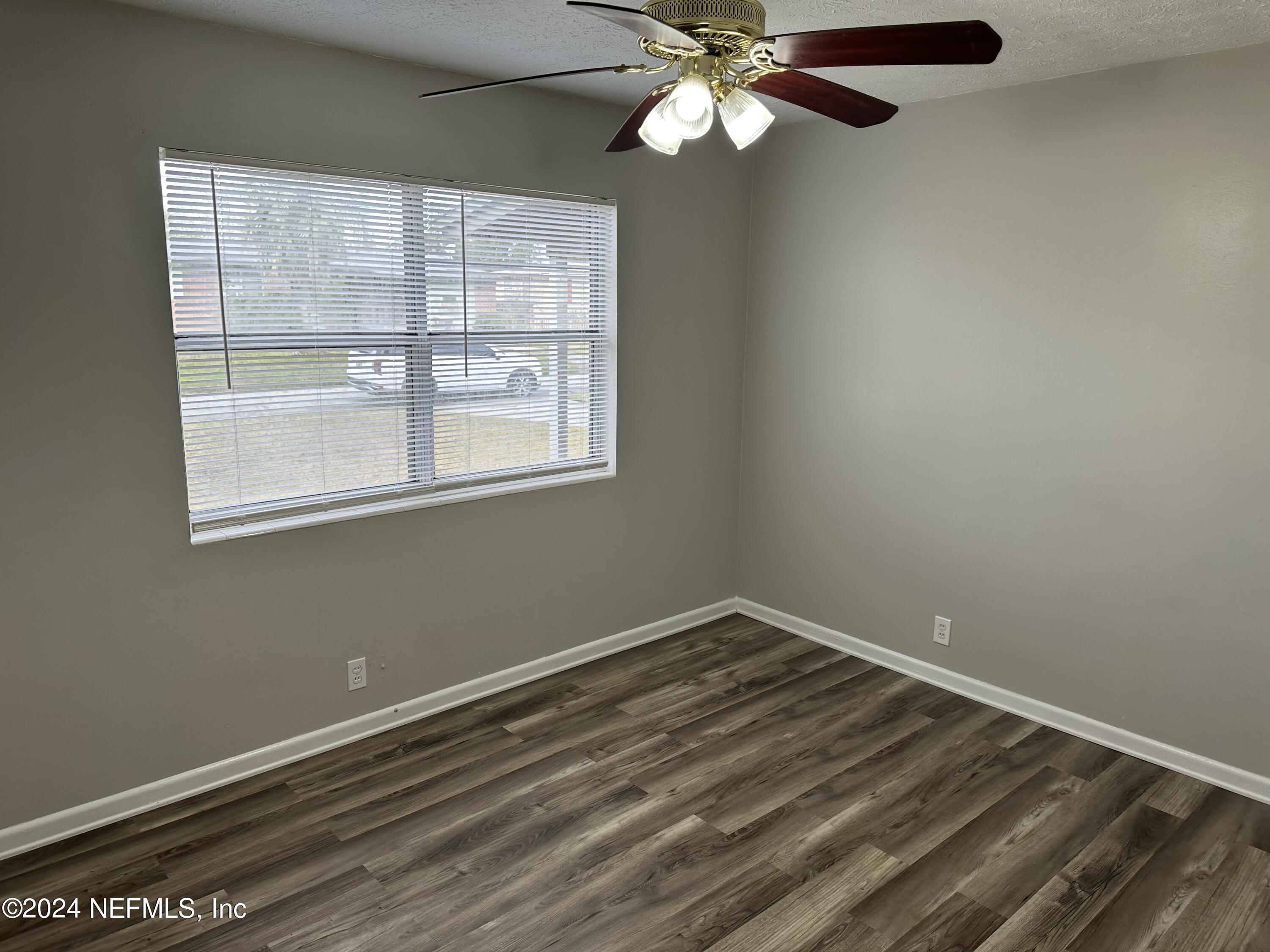 7417 Coral Sea Road Jacksonville, FL 32244 - Photo 8 of 10 a view of an empty room with a window