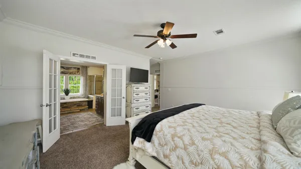 a spacious bedroom with a bed and a window