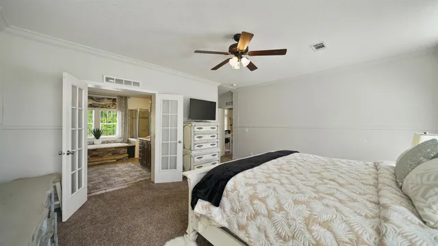 a spacious bedroom with a bed and a window