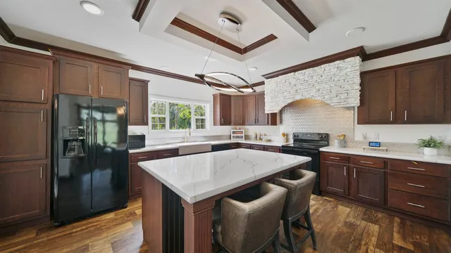 a kitchen with a table chairs refrigerator and cabinets