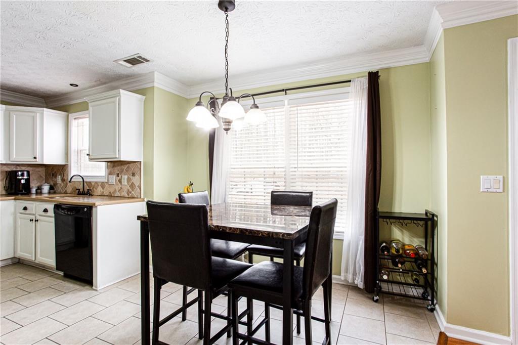 20 Trelawney Run Covington, GA 30016 - Photo 11 of 26 a kitchen with a table chairs and refrigerator