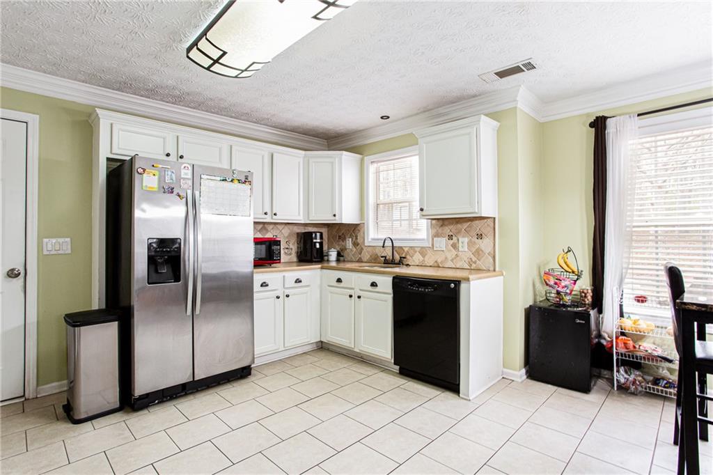 20 Trelawney Run Covington, GA 30016 - Photo 13 of 26 a kitchen with a refrigerator a sink and cabinets