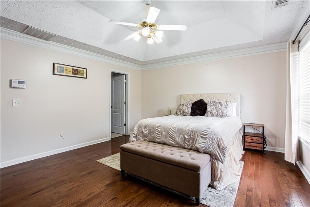 20 Trelawney Run Covington, GA 30016 - Photo 19 of 26 a bedroom with a bed and wooden floor
