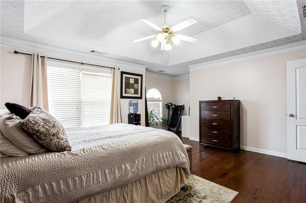 20 Trelawney Run Covington, GA 30016 - Photo 20 of 26 a bedroom with a bed and wooden floor