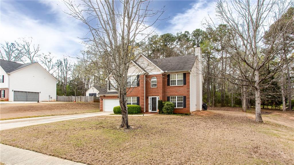 20 Trelawney Run Covington, GA 30016 - Photo 3 of 26 a view of a house with a yard and garage