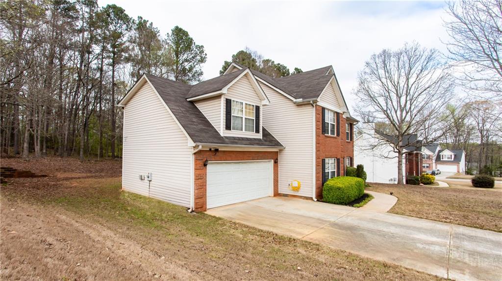 20 Trelawney Run Covington, GA 30016 - Photo 4 of 26 a view of a white house with a large space in front of it