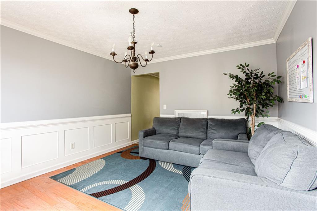 20 Trelawney Run Covington, GA 30016 - Photo 7 of 26 a living room with furniture and a chandelier