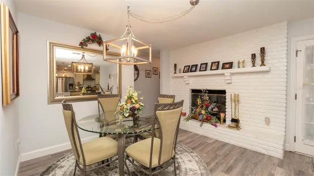 a view of a dining room with furniture and chandelier