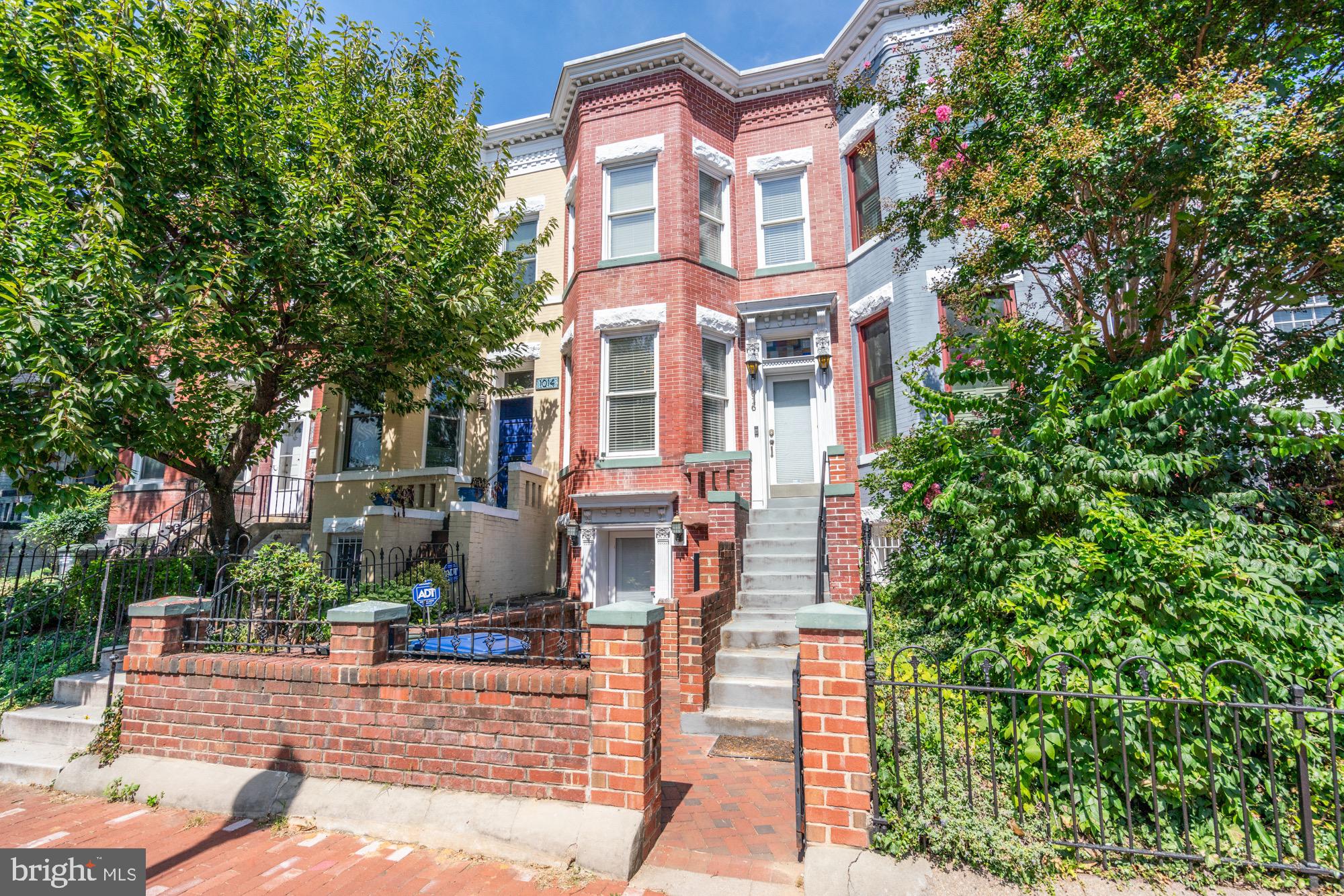 1016 G Street Southeast Washington, DC 20003 - Photo 1 of 56 a front view of a house with a garden
