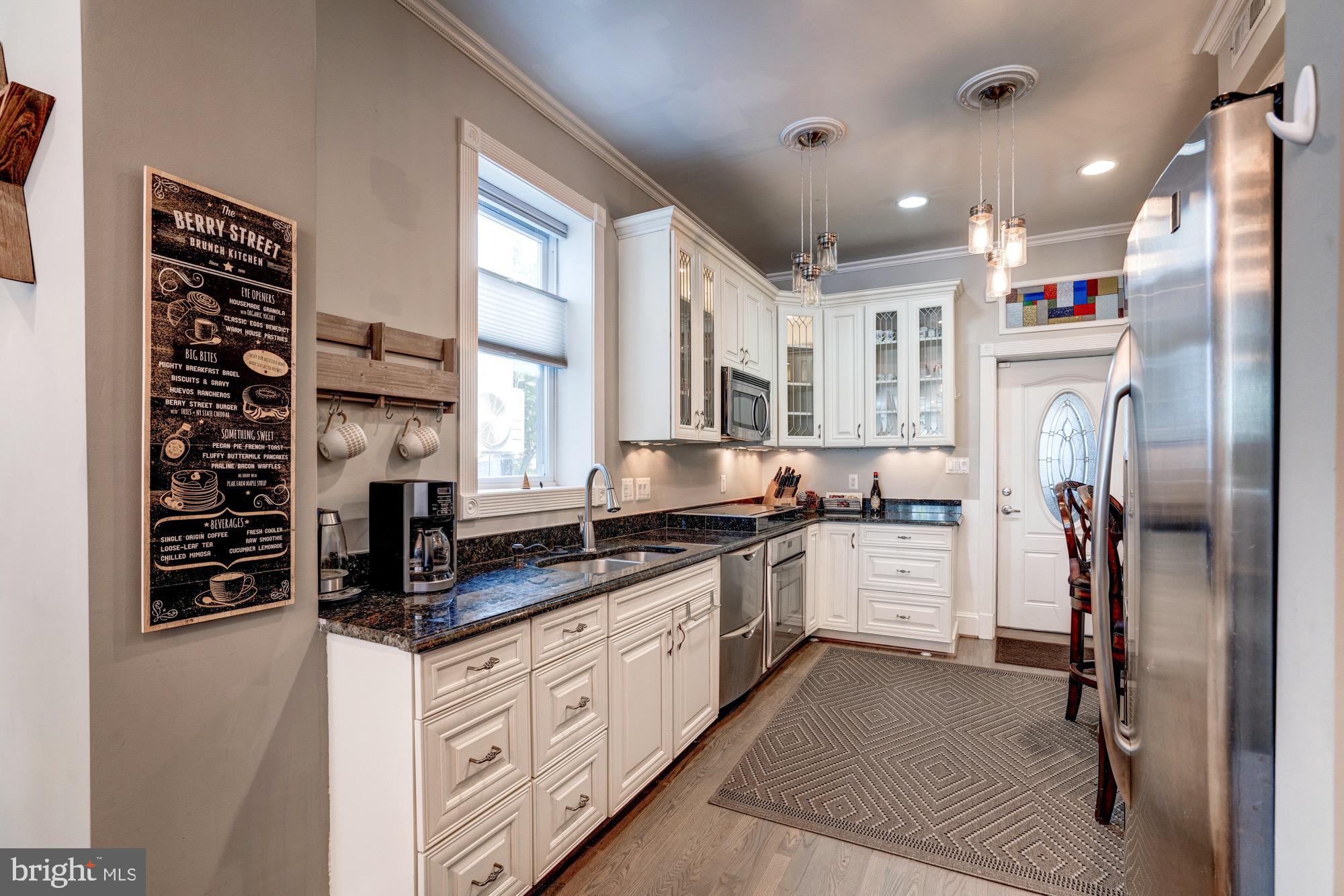 1016 G Street Southeast Washington, DC 20003 - Photo 14 of 56 a kitchen with stainless steel appliances a refrigerator sink and cabinets
