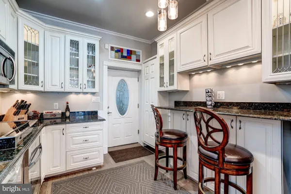 a kitchen with stainless steel appliances granite countertop a stove a sink and cabinets