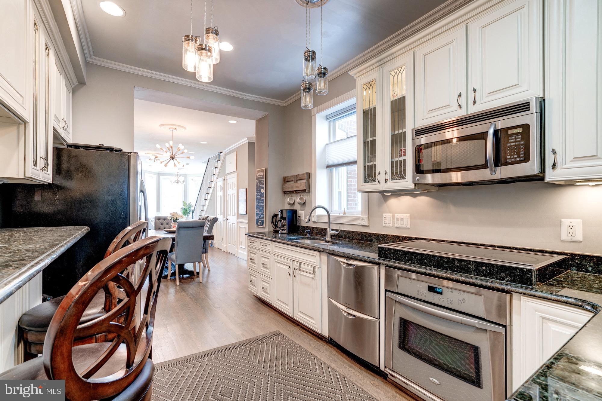 1016 G Street Southeast Washington, DC 20003 - Photo 19 of 56 a kitchen with stainless steel appliances granite countertop a stove a sink dishwasher and a microwave oven with cabinets