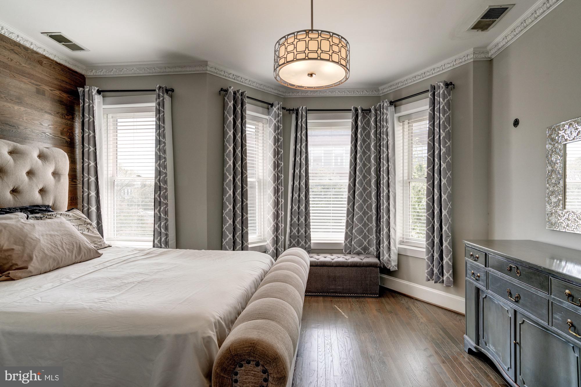 1016 G Street Southeast Washington, DC 20003 - Photo 29 of 56 a bedroom with a bed and a chandelier