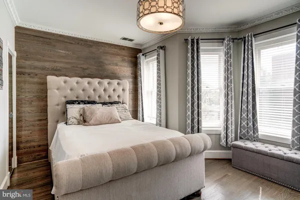 a bedroom with a bed and a large window
