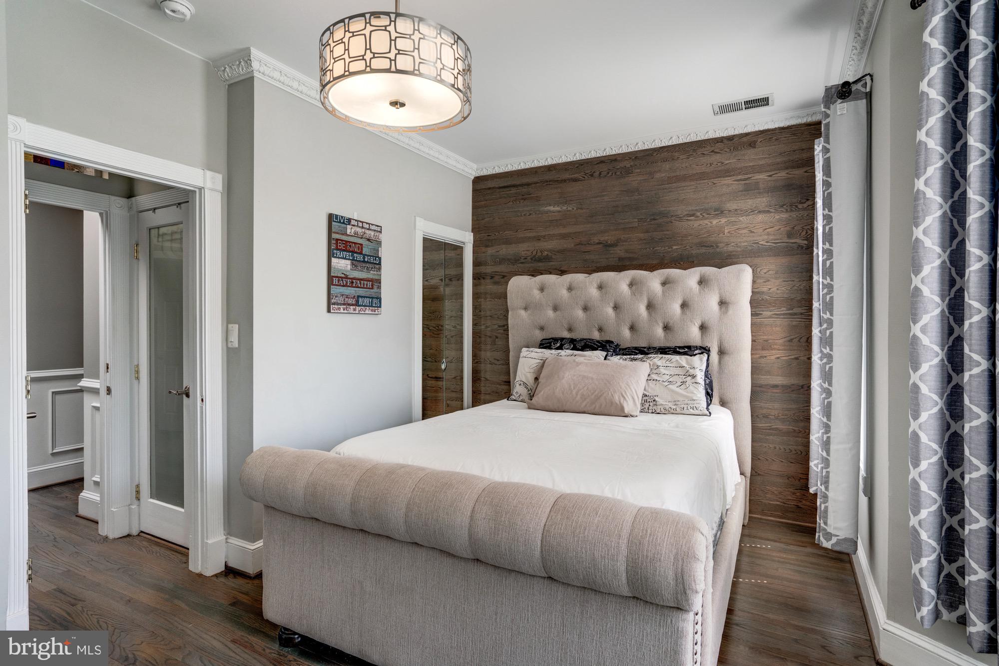 1016 G Street Southeast Washington, DC 20003 - Photo 31 of 56 a bedroom with a large bed and a chandelier