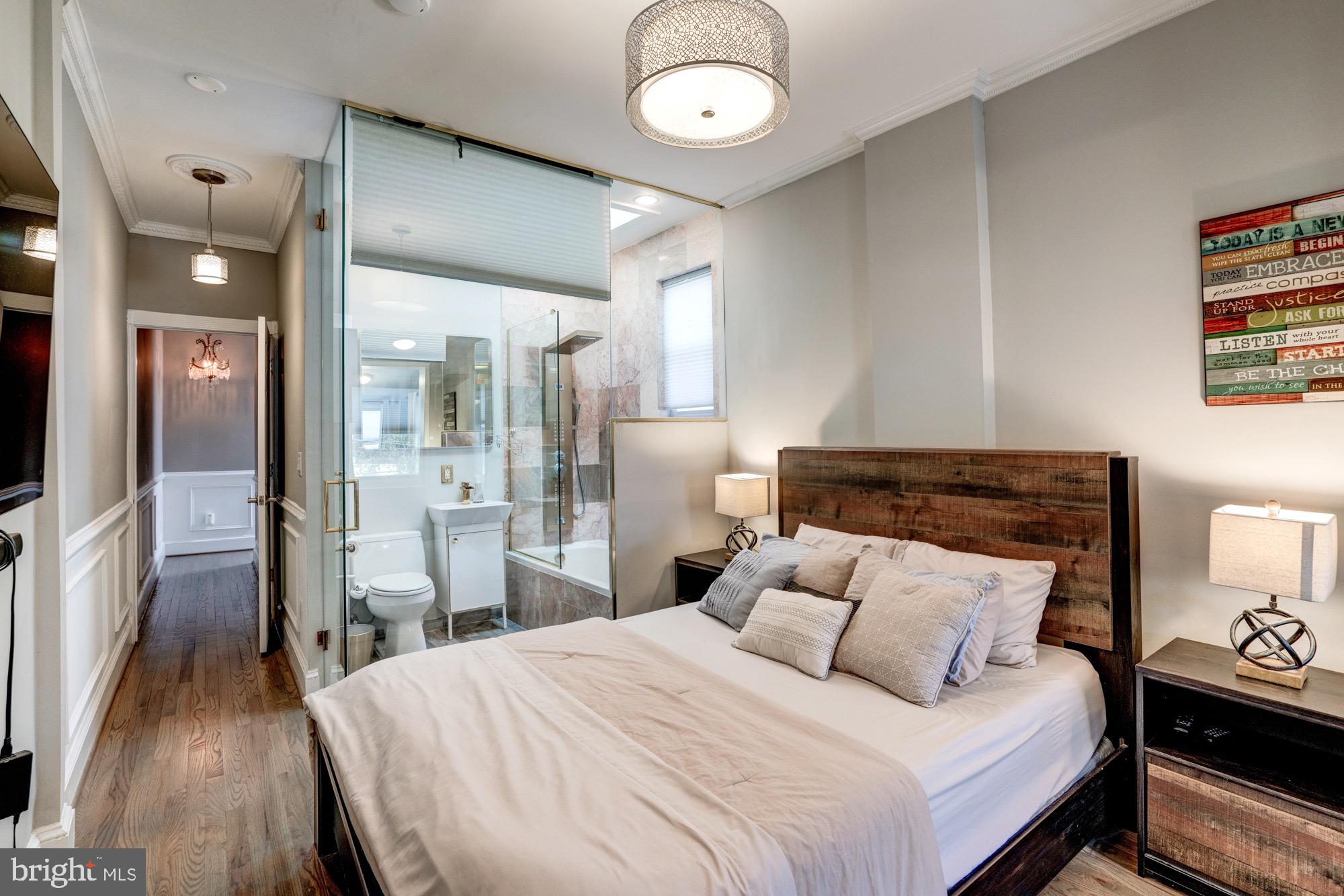 1016 G Street Southeast Washington, DC 20003 - Photo 35 of 56 a bedroom with a bed and a table in it