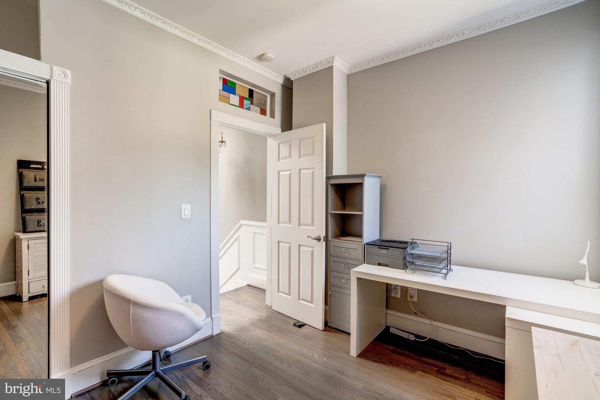 1016 G Street Southeast Washington, DC 20003 - Photo 42 of 56 a kitchen with a refrigerator and chair