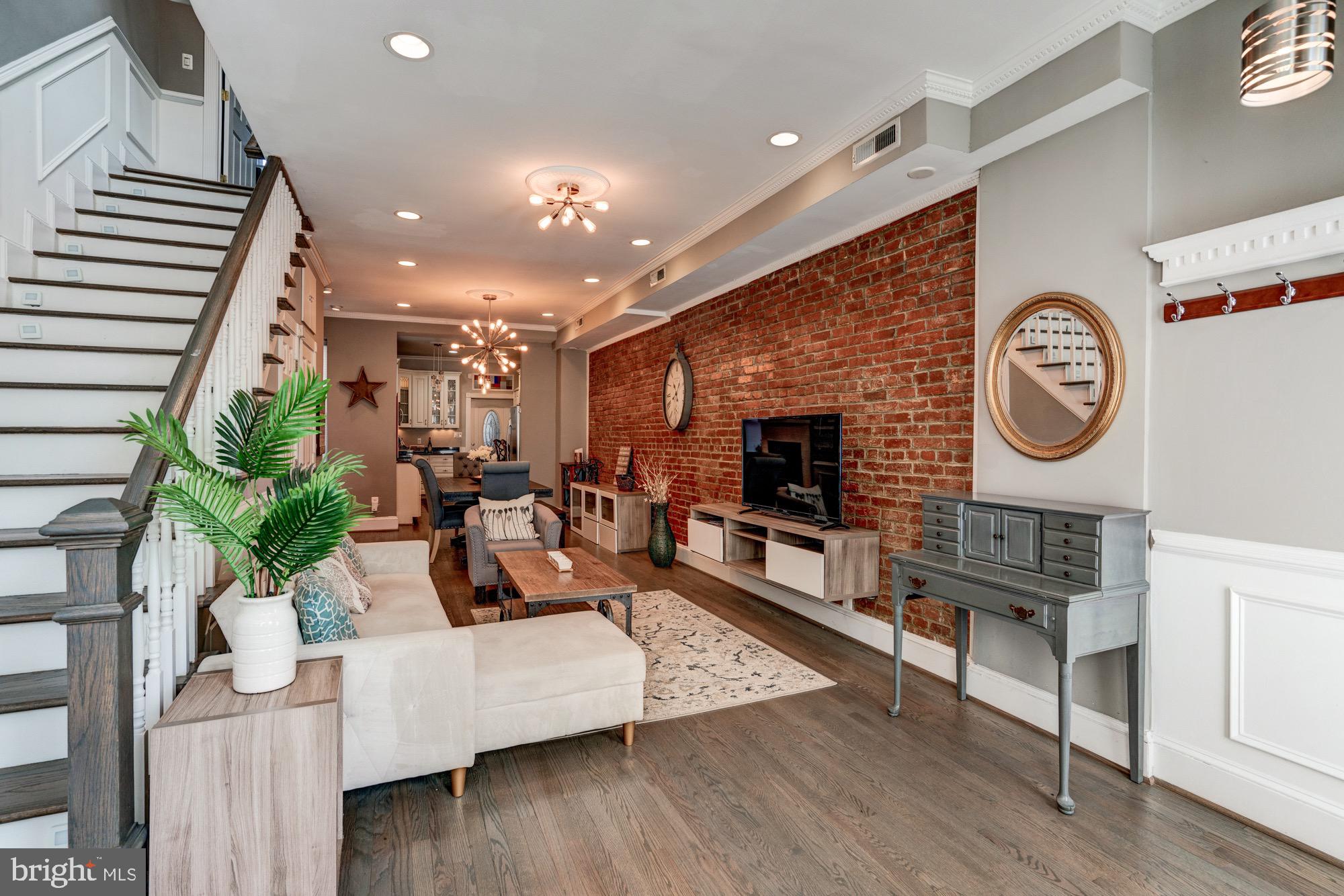 1016 G Street Southeast Washington, DC 20003 - Photo 5 of 56 a living room with furniture a clock on wall and a clock