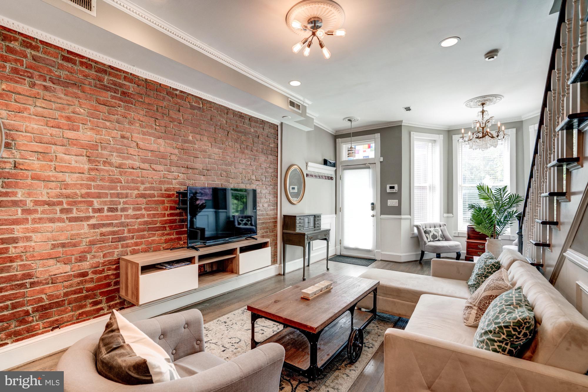 1016 G Street Southeast Washington, DC 20003 - Photo 9 of 56 a living room with furniture and a flat screen tv